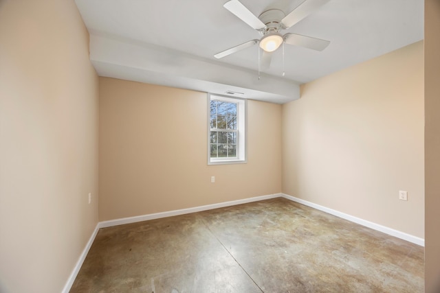 unfurnished room with ceiling fan and concrete flooring