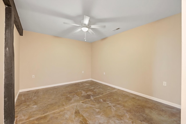 unfurnished room with ceiling fan and concrete flooring