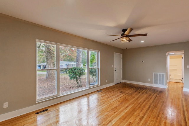 empty room featuring ceiling fan, light hardwood / wood-style flooring, and ornamental molding