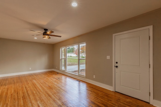 unfurnished room with light hardwood / wood-style floors, ceiling fan, and ornamental molding