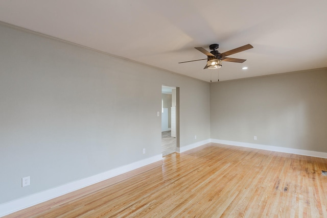 unfurnished room with ceiling fan, light hardwood / wood-style floors, and ornamental molding