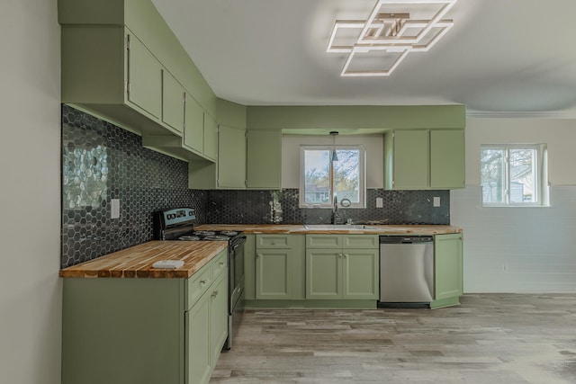 kitchen featuring butcher block counters, stainless steel appliances, green cabinets, and sink