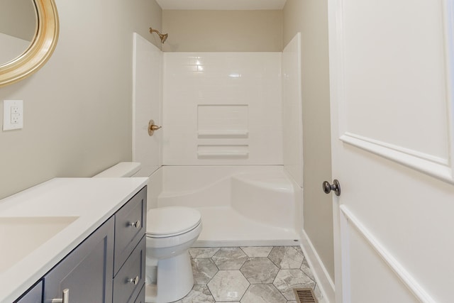 bathroom with a shower, tile patterned floors, vanity, and toilet