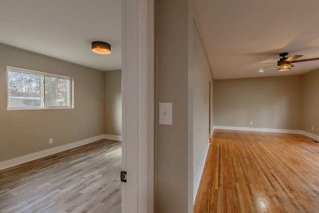 spare room with light wood-type flooring and ceiling fan