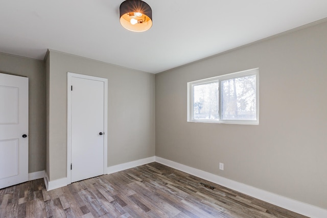 spare room with hardwood / wood-style flooring and ornamental molding