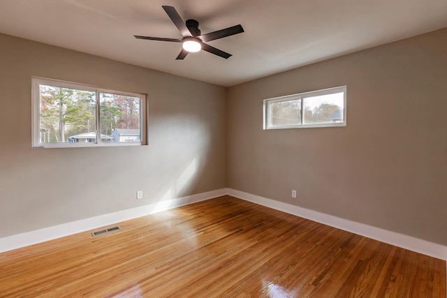 empty room with ceiling fan and wood-type flooring