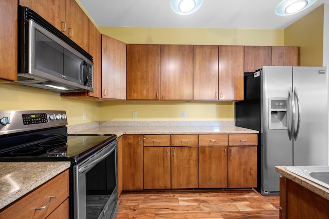 kitchen featuring light hardwood / wood-style floors and appliances with stainless steel finishes