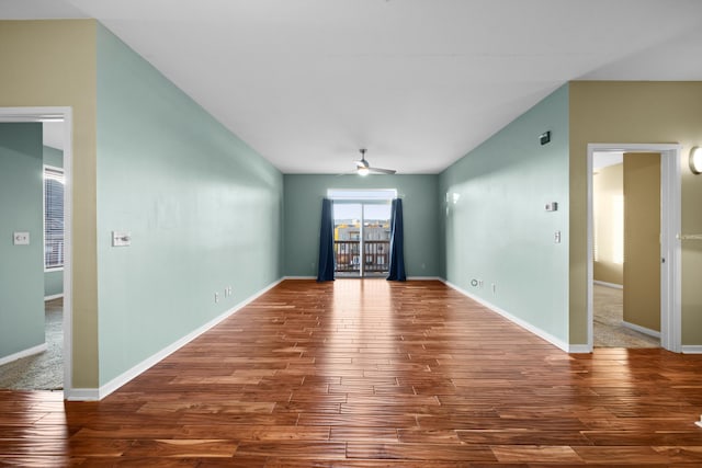 unfurnished room featuring hardwood / wood-style floors, ceiling fan, and vaulted ceiling