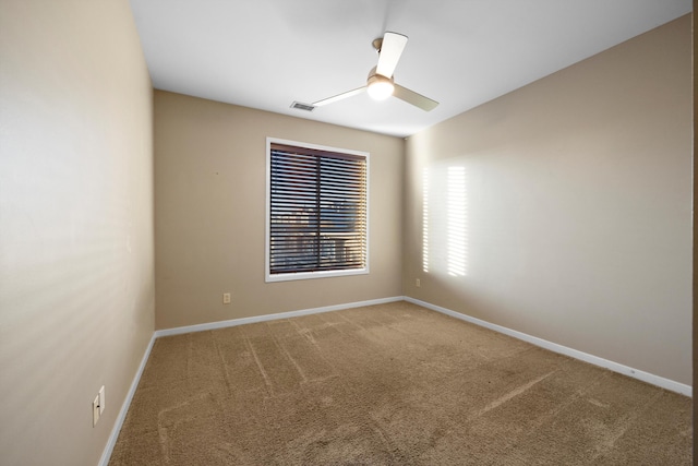 empty room featuring carpet floors and ceiling fan