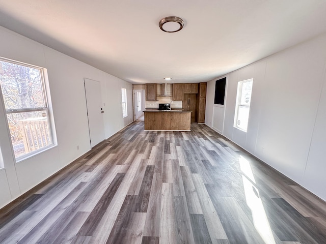 unfurnished living room with dark wood-type flooring