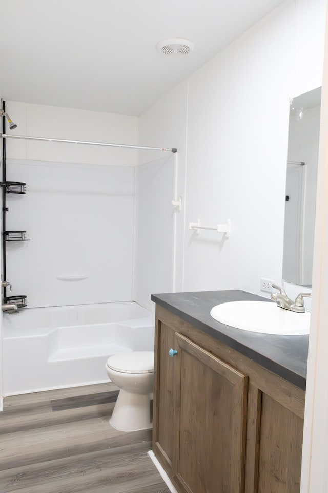 bathroom featuring vanity, toilet, and wood-type flooring