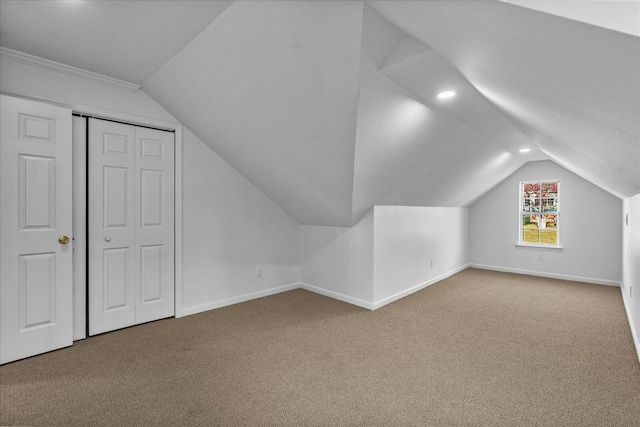 bonus room featuring carpet floors and vaulted ceiling