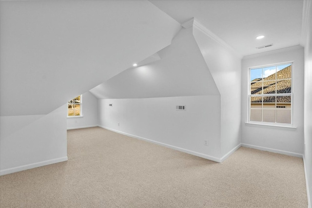 bonus room featuring light carpet and vaulted ceiling