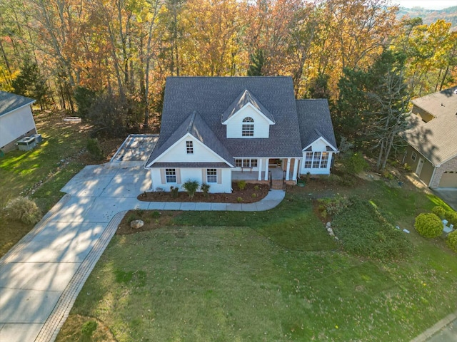 new england style home featuring a porch and a front yard