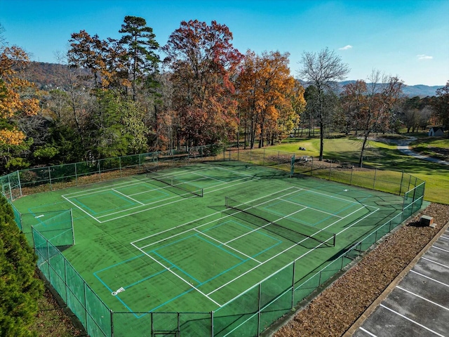 view of tennis court with a mountain view