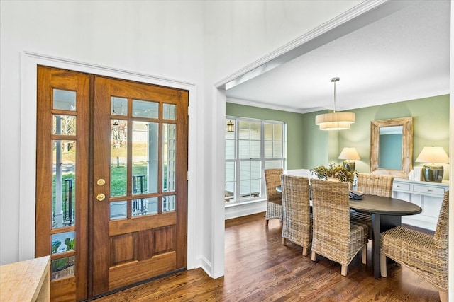 dining area featuring crown molding, dark wood-type flooring, and a healthy amount of sunlight