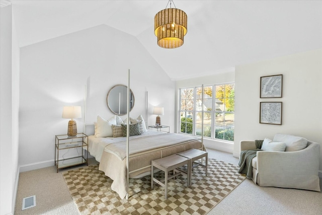 bedroom with lofted ceiling and light carpet