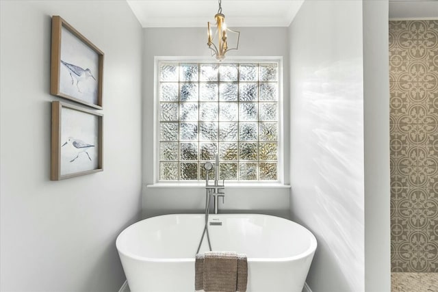 bathroom with a tub, crown molding, and a healthy amount of sunlight