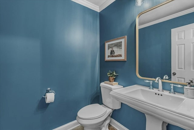 bathroom featuring sink, ornamental molding, and toilet