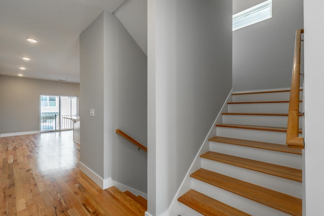 stairs with hardwood / wood-style flooring