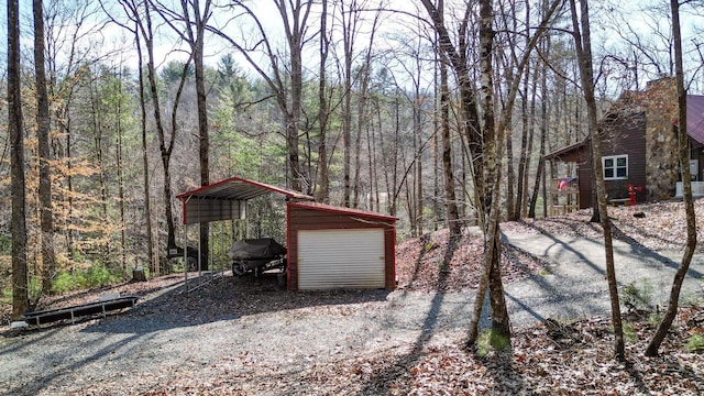 view of yard featuring a garage and a carport