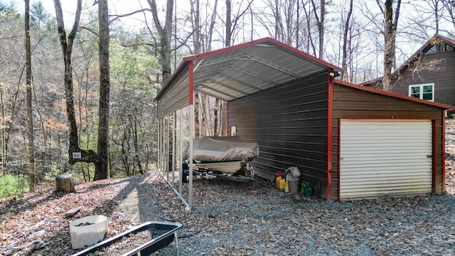 view of side of home with an outbuilding, a garage, and a carport