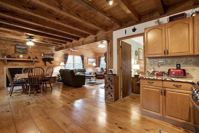 interior space with ceiling fan, light stone countertops, and light wood-type flooring