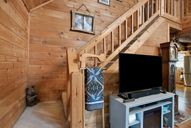 staircase featuring wooden walls