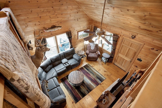 unfurnished living room with lofted ceiling, hardwood / wood-style floors, wood ceiling, and wood walls