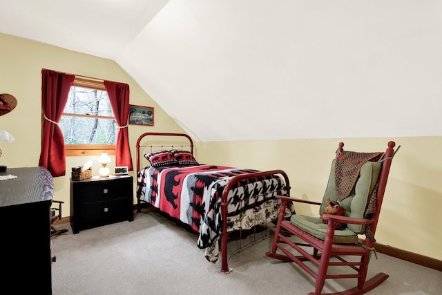 carpeted bedroom featuring lofted ceiling