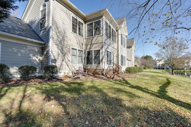 rear view of property with a yard