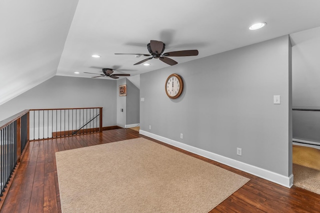 interior space with ceiling fan, dark hardwood / wood-style flooring, and lofted ceiling