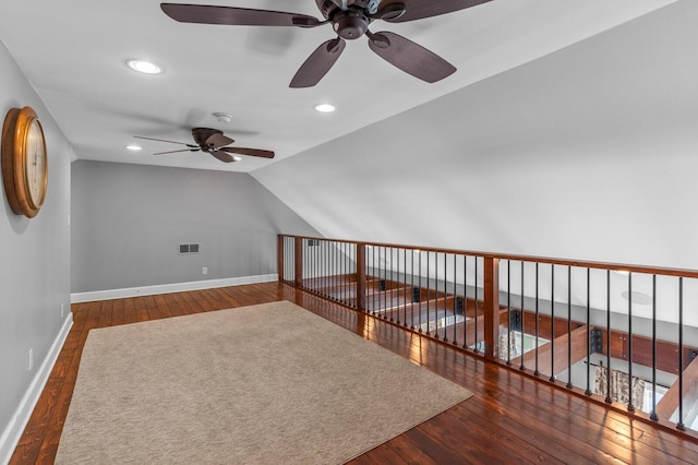 additional living space featuring ceiling fan, dark hardwood / wood-style flooring, and vaulted ceiling