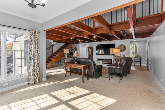 carpeted living room featuring beamed ceiling, crown molding, and a chandelier