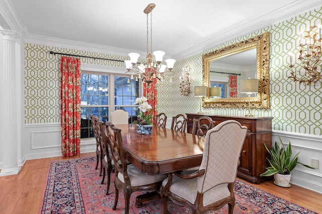 dining space with a notable chandelier, light wood-type flooring, and crown molding