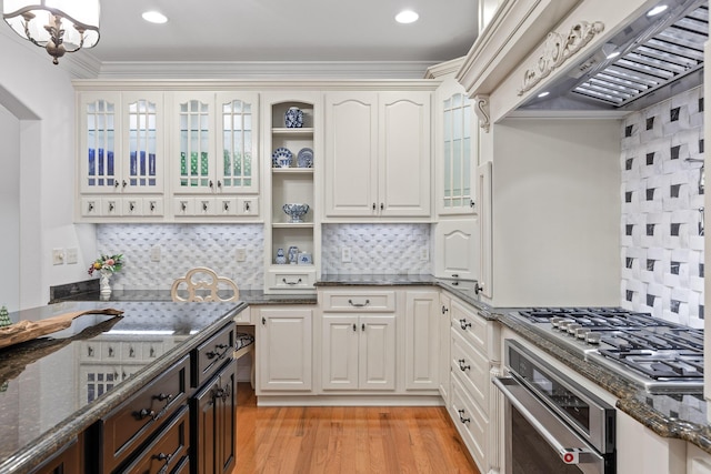 kitchen with backsplash, stainless steel appliances, dark stone countertops, and custom exhaust hood