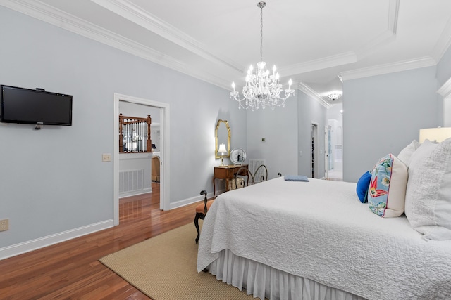 bedroom with dark hardwood / wood-style flooring, crown molding, and a chandelier