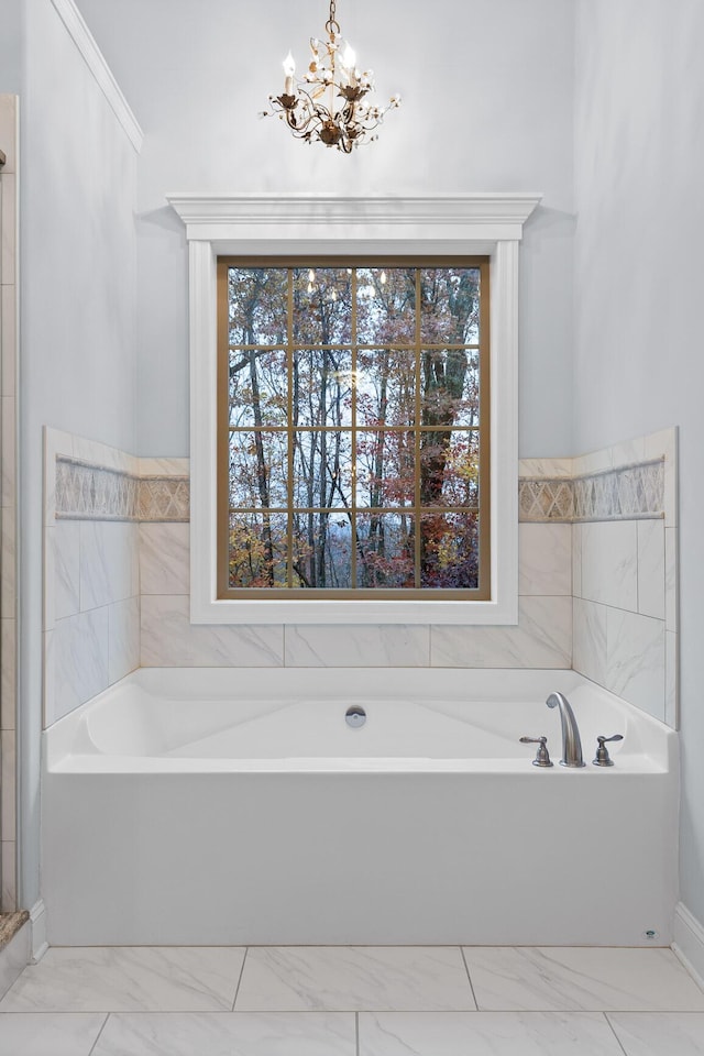 bathroom featuring a healthy amount of sunlight and a chandelier