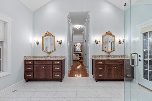 bathroom with hardwood / wood-style floors, vanity, and high vaulted ceiling