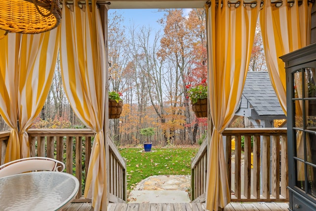 wooden terrace with a lawn