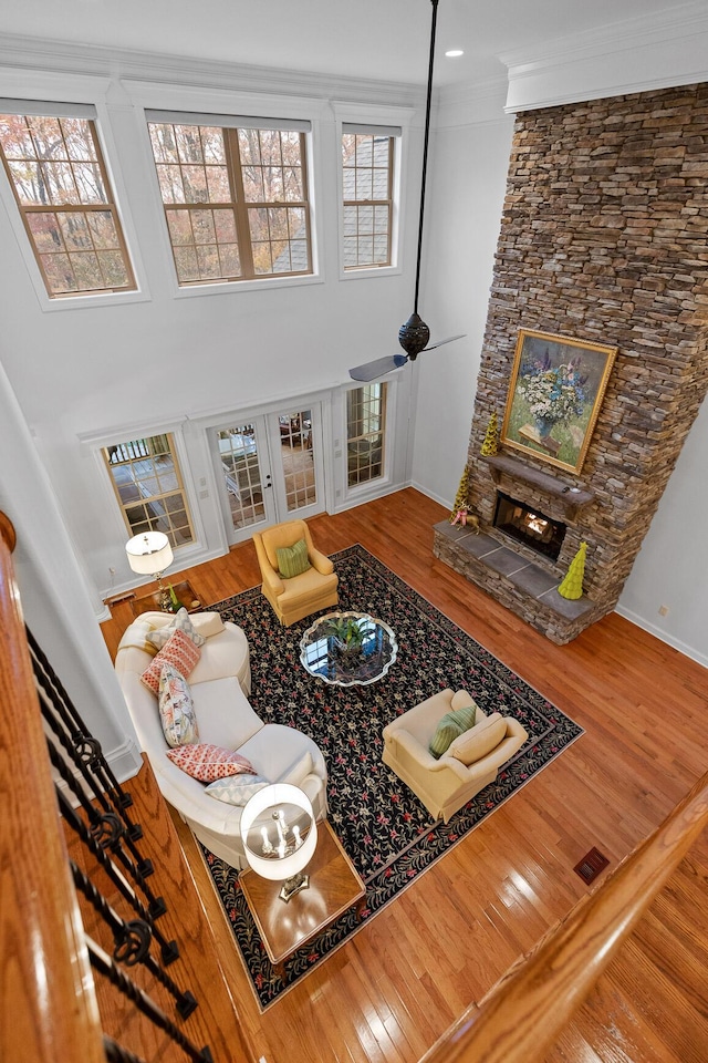 living room with plenty of natural light, ornamental molding, and hardwood / wood-style flooring