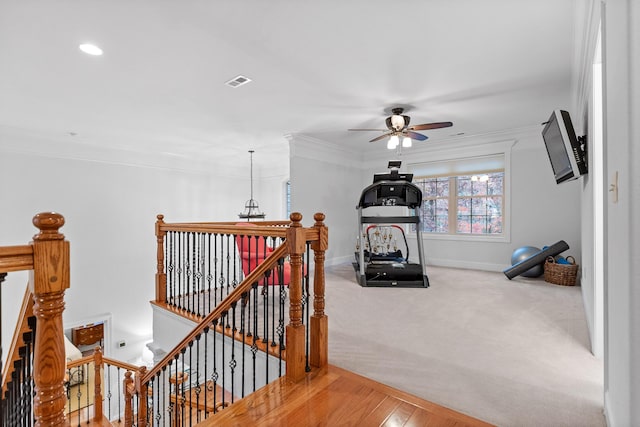 interior space with crown molding, hardwood / wood-style floors, and ceiling fan