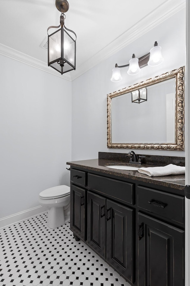 bathroom featuring tile patterned floors, vanity, toilet, and crown molding