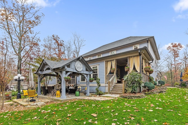 back of house featuring a gazebo and a lawn