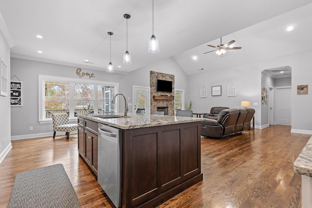 kitchen featuring dark hardwood / wood-style flooring, dark brown cabinets, light stone countertops, stainless steel dishwasher, and sink