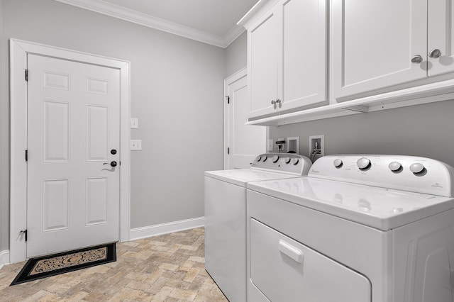 laundry area with cabinets, washer and dryer, and crown molding