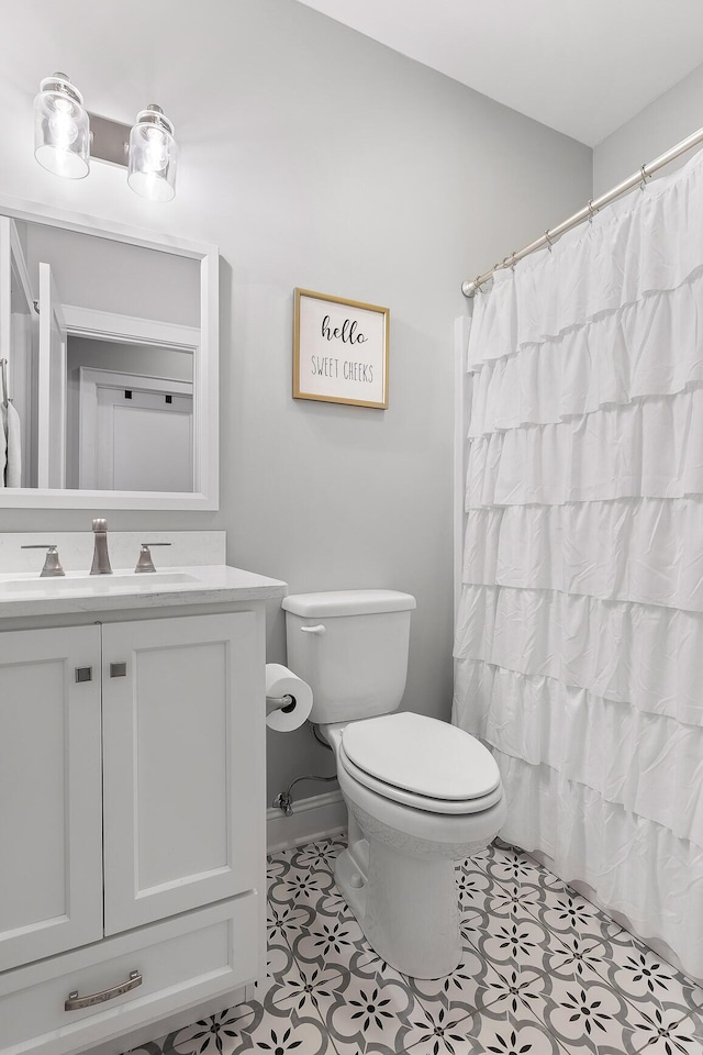 bathroom with toilet, a shower with shower curtain, tile patterned flooring, and vanity