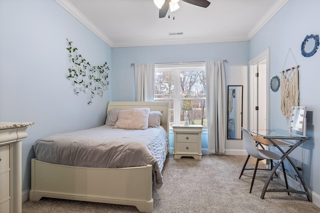 carpeted bedroom with ceiling fan and ornamental molding