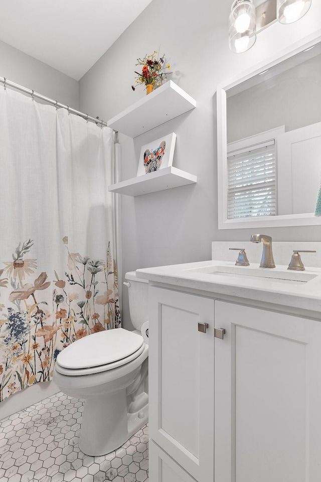 bathroom featuring tile patterned floors, toilet, and vanity