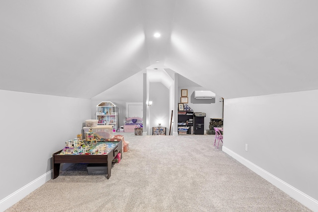 rec room featuring vaulted ceiling, a wall mounted air conditioner, and carpet flooring